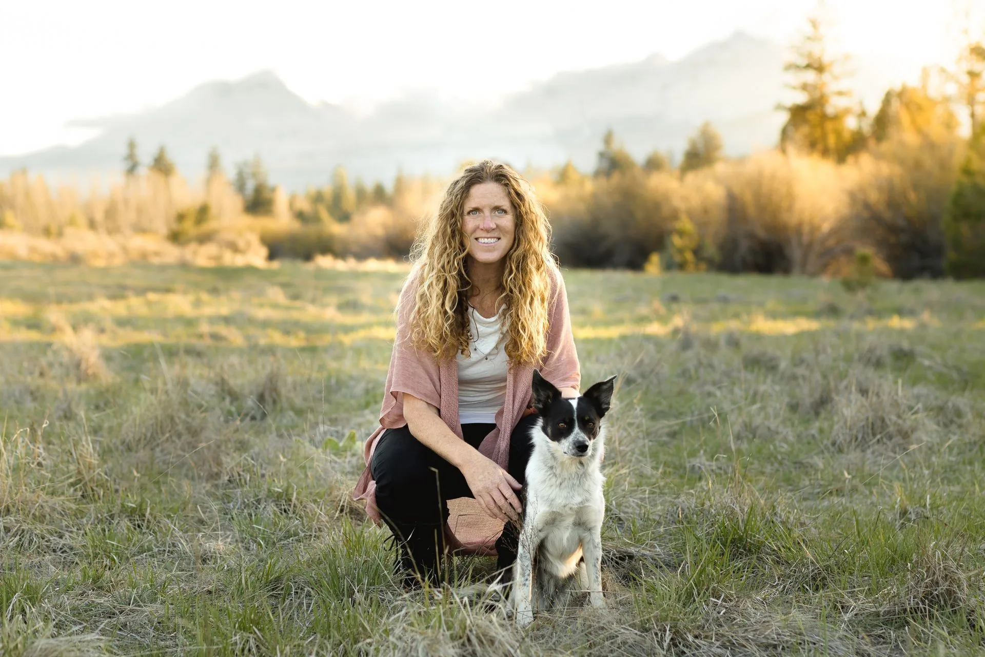 Kelly Miller with her dog in a Central Oregon field